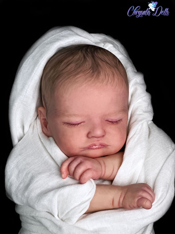 Reborn Rosalie is sleeping wrapped in a white blanket with blackground.